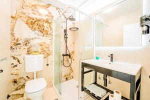 a bathroom with a shower and a toilet and a sink at Resort Trcol in Novalja +52 photos