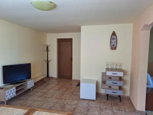 a living room with a flat screen tv next to a door at Guest Rooms Flirt in Golden Sands +43 photos