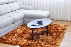 a living room with a table and a couch at Apartmento - Casa dos Meninos in Godim