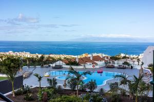 a view of a resort with a large swimming pool at Costa Adeje Garden Aparthotel in Adeje