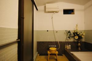 a bathroom with a shower and a toilet and a sink at Rakumankan in Kyoto