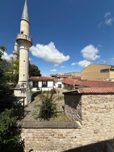a mosque with a tall tower in a city at FAMİLY PLAs HOME in Edirne