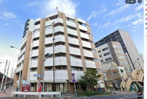 a building on a street with two tall buildings at Home Story in Tokyo Ueno&Uguisudani-小島ビル&東京屋語 in Tokyo