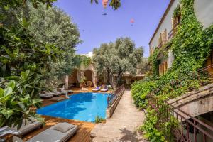 a pool in the middle of a house with trees at Jade Residence in Oludeniz