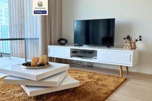 a living room with a television on a white entertainment center at Sea View 1 BR Flat With Pool - Ideal For Couples & Families By SlowayStay Holiday Apartment & Short Term Rental Oostende in Ostend