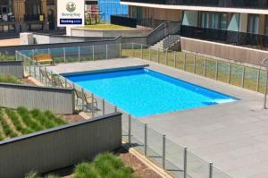 a swimming pool in the middle of a building at Sea View 1 BR Flat With Pool - Ideal For Couples & Families By SlowayStay Holiday Apartment & Short Term Rental Oostende in Ostend