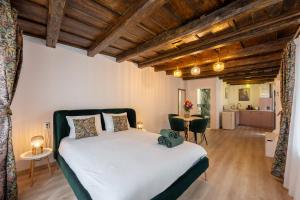 a bedroom with a large bed and a table at House Four in Sighişoara