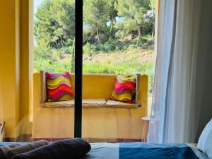 a room with a window with two pillows on a bench at Green Hill Apartment in La Cala de Mijas +43 photos