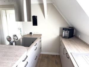 a kitchen with a sink and a counter top at Stilvolle Dachgeschosswohnung am Teutoburger Wald in Steinhagen