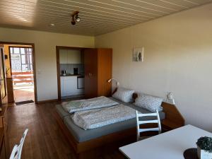 a small room with a bed and a table at Campingplatz Weserterrassen Polle in Polle