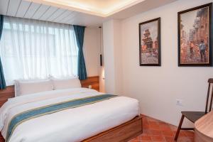 Letto o letti in una camera di Harsha Boutique Hotel