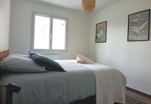 a bedroom with a bed and a window at L'Orge - Maison Design, 3 chambres, jardin et garage privatif in Vic-le-Comte
