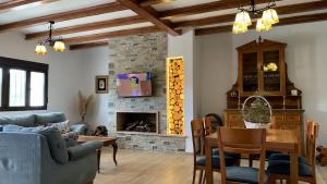 a living room with a table and a fireplace at Dos casas rurales con piscina in Caravaca de la Cruz