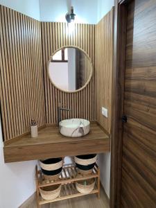 a bathroom with a sink and a mirror at Dos casas rurales con piscina in Caravaca de la Cruz