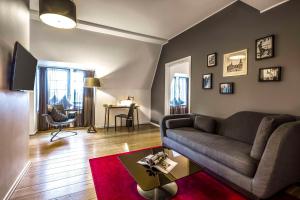 a living room with a couch and a table at Scandic Palace Hotel in Copenhagen