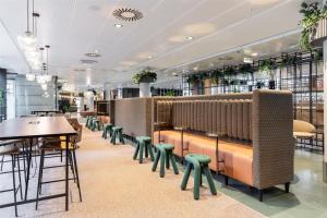 a row of tables and chairs in a restaurant at Scandic Simonkenttä in Helsinki