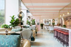 a restaurant with tables and chairs and a bar at Haymarket by Scandic in Stockholm