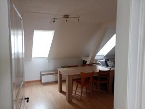 a dining room with a table and some chairs at Gemütliches Dach-Zimmer in St. Gallen