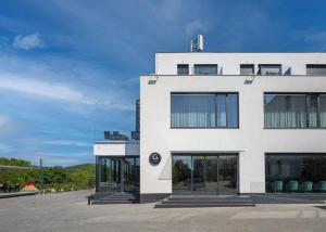 a white building with large windows on the side of it at Hotel Golf Prague in Prague