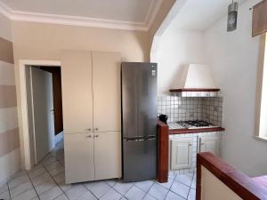 a kitchen with a stainless steel refrigerator at Brezza di mare in Zingarello