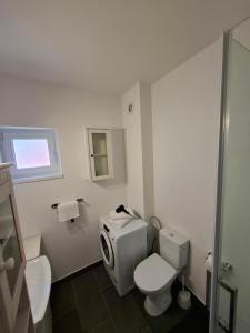 ein weißes Badezimmer mit Toilette und Waschbecken in der Unterkunft SAB Apartament Mamaia Nord-Navodari in Mamaia Nord – Năvodari + 35 Fotos