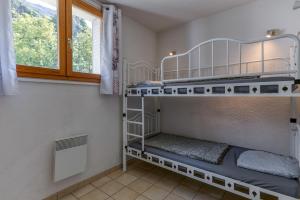 a room with bunk beds in it with a window at Les Lys Orangés in Le Bourg d'oisans