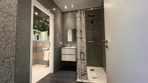 a bathroom with a shower and a sink at Domus Hotel in Luxembourg +37 photos