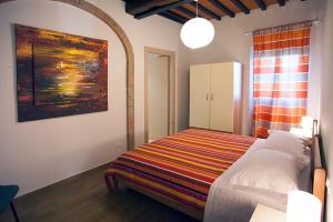 Postel nebo postele na pokoji v ubytování Agriturismo Fattoria Loppiano 4-0
