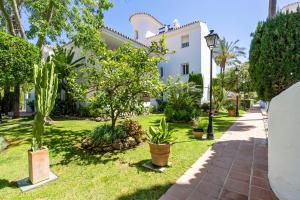 a house with trees and plants in a yard at Nice Casa los Naranjos Marbella by Casa del Sol HR in Marbella