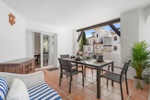 a living room with a dining room table and chairs at Nice Casa los Naranjos Marbella by Casa del Sol HR in Marbella