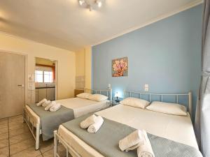 Posteľ alebo postele v izbe v ubytovaní Chariclia Hotel