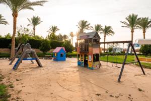 a playground with play equipment in the sand at Sentido Caribbean World Soma Bay in Hurghada
