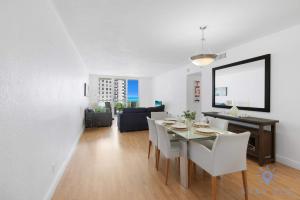 a dining room and living room with a table and chairs at Tides beautiful ocean view condo-promotions in Hollywood