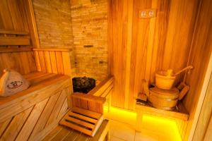 a wooden sauna with a toilet and a chair at Harvest in Vinnytsya
