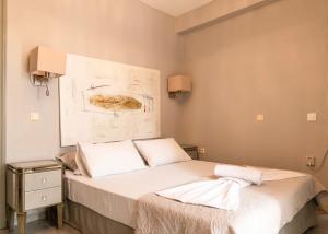a bedroom with two beds and a painting on the wall at Silot apartment 1 in Nea Fokea