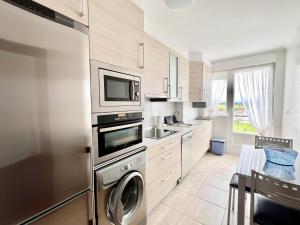 a kitchen with a washer and dryer in it at Apartamento La Cala Cuchía - Monabri in Cuchia