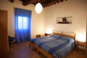 Postel nebo postele na pokoji v ubytování Agriturismo Fattoria Loppiano 4-0