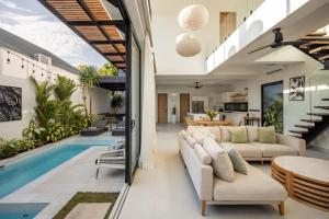 an open living room with a pool and a villa at Spacious 3 bedroom villa - Walk to the beach in Uluwatu