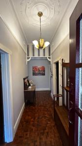 a hallway with a ceiling with a chandelier at Botanic Bliss Bungalow in Adelaide