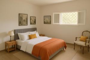 a bedroom with a bed and a window and a chair at Villa Giulia in Lecce +53 photos