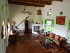 a living room with a couch and a fireplace at Punjab Village Farm near Amritsar in Gurdāspur