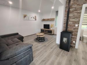 a living room with a couch and a wood stove at A Casa Pequena INCostadaMorte in Cee