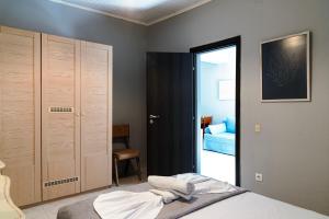 a bedroom with a bed and a door to a bathroom at Silot apartment 4 in Nea Fokea