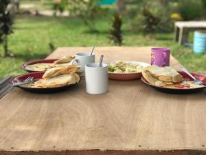 a table with two plates of food on it at Garden Lodge - Cape Three Points in Atinchin