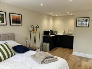 a bedroom with a bed and a kitchen with a microwave at Imaginarium in Southampton