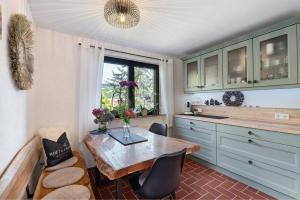 a kitchen with a table and chairs and a window at Haus Schwarzwald Königin in Bühlertal
