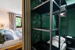 a bedroom with a bunk bed and a green wall at Haus Schwarzwald Königin in Bühlertal
