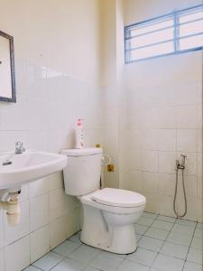 a bathroom with a toilet and a sink at Raisa Homestay KLIA by Xpresso Home in Sepang