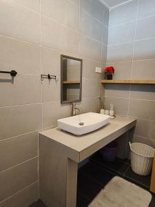 a bathroom with a white sink and a mirror at Vi Sweet Home- Luak in Gua Sai +11 photos