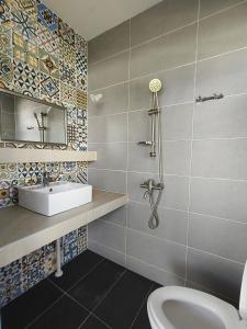 a bathroom with a toilet and a sink at Vi Sweet Home- Luak in Gua Sai